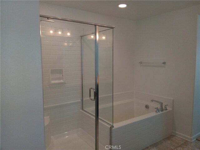 bathroom featuring independent shower and bath and tile patterned flooring