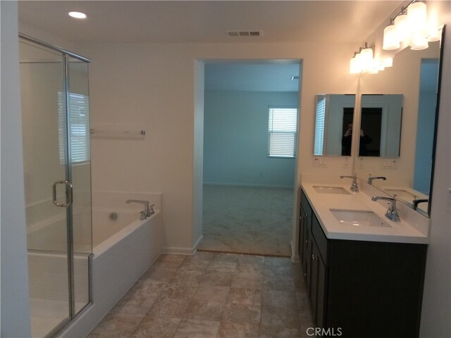 bathroom featuring vanity and shower with separate bathtub