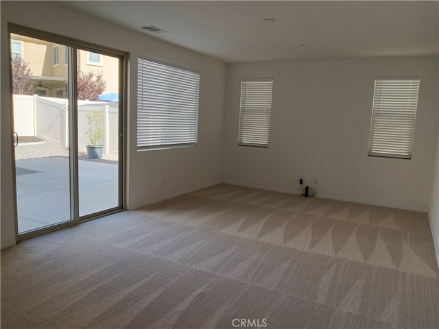 unfurnished room with light colored carpet