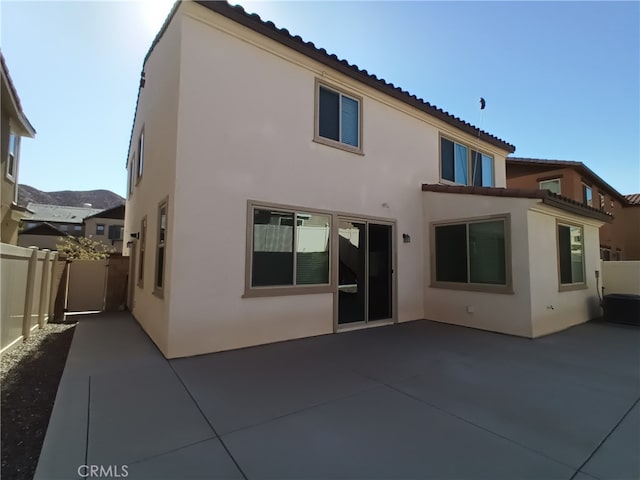 back of property with a patio