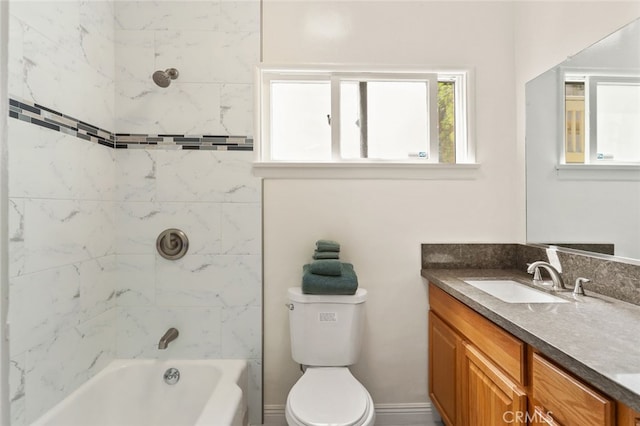 full bathroom with vanity, tiled shower / bath, and toilet