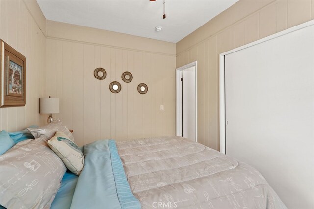 bedroom with wooden walls