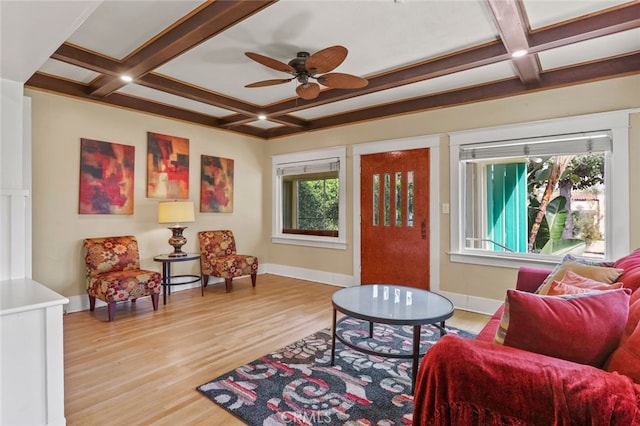 sitting room with beamed ceiling, coffered ceiling, and light wood-type flooring