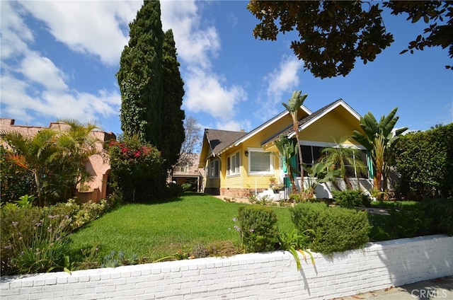 view of side of home featuring a yard