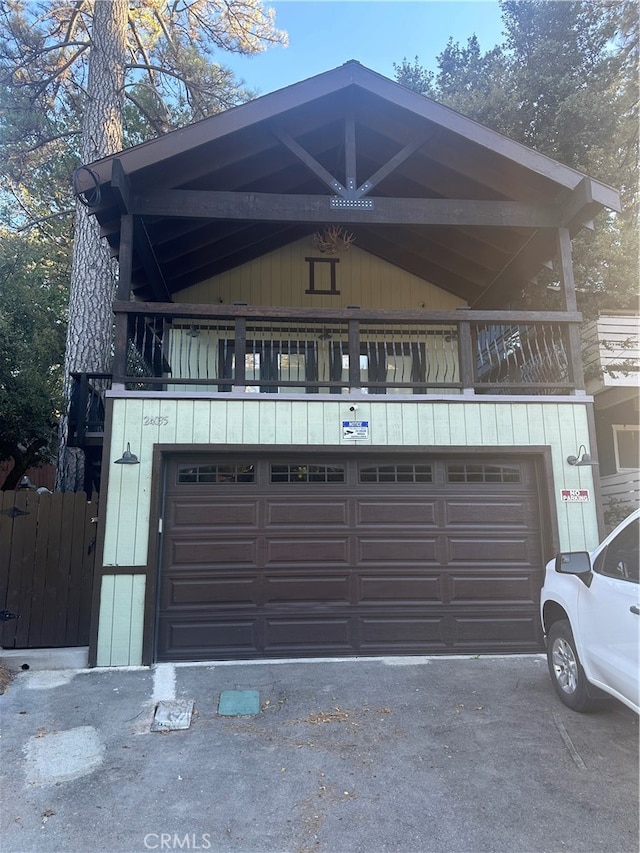 view of front of home featuring a balcony and a garage