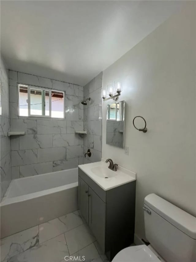 full bathroom featuring vanity, tiled shower / bath combo, and toilet