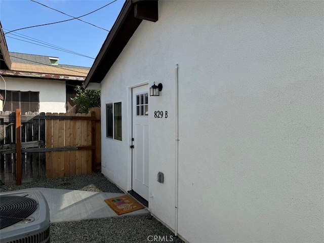 property entrance featuring central AC unit