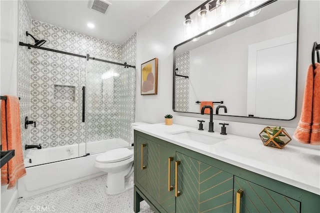 full bathroom with tile patterned flooring, vanity, toilet, and shower / bath combination with glass door