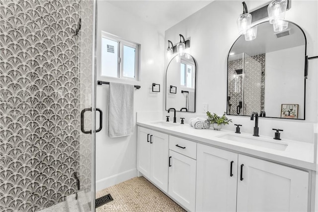 bathroom featuring tile patterned flooring, vanity, and a shower with door