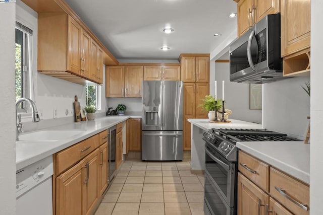 kitchen with light tile patterned flooring, sink, and stainless steel appliances