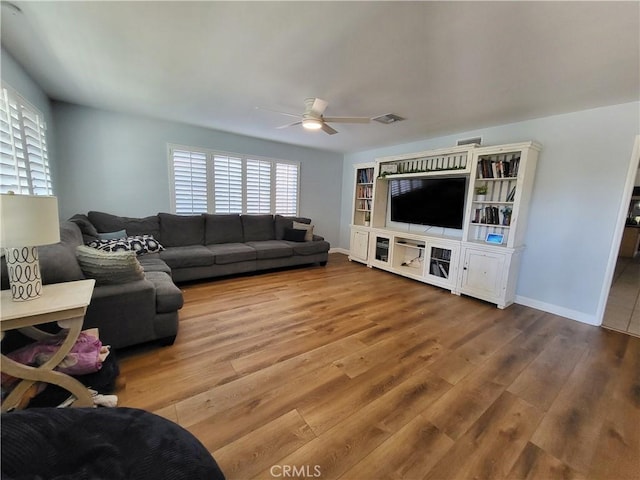 living room with ceiling fan and hardwood / wood-style flooring