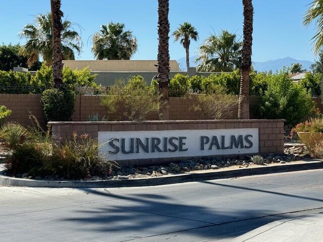 community / neighborhood sign with a mountain view