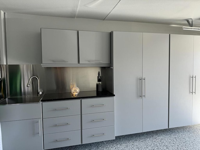 kitchen with white cabinetry and sink