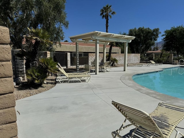 view of swimming pool featuring a patio and a pergola