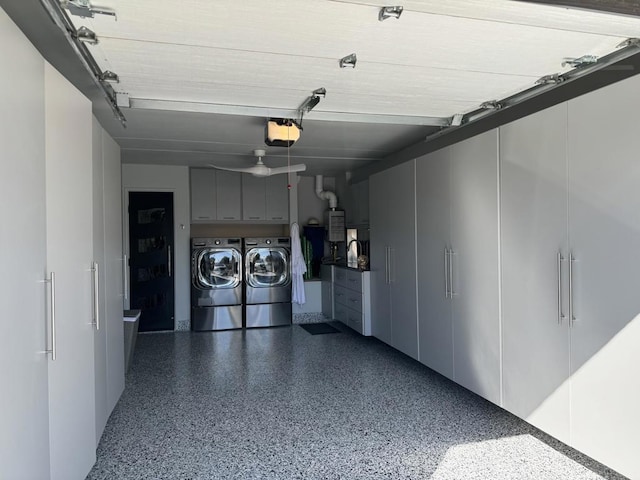 garage with a garage door opener, water heater, and washer and dryer