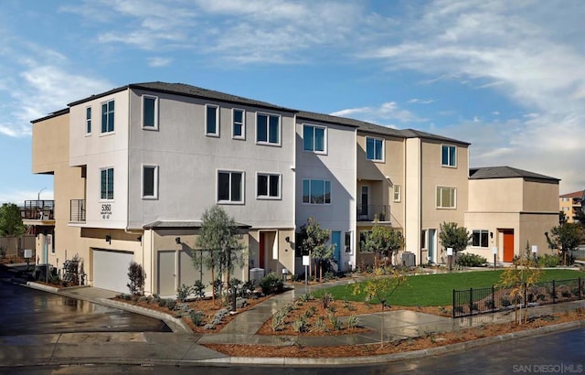 exterior space with a garage and central air condition unit