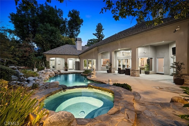 view of pool featuring an in ground hot tub and a patio