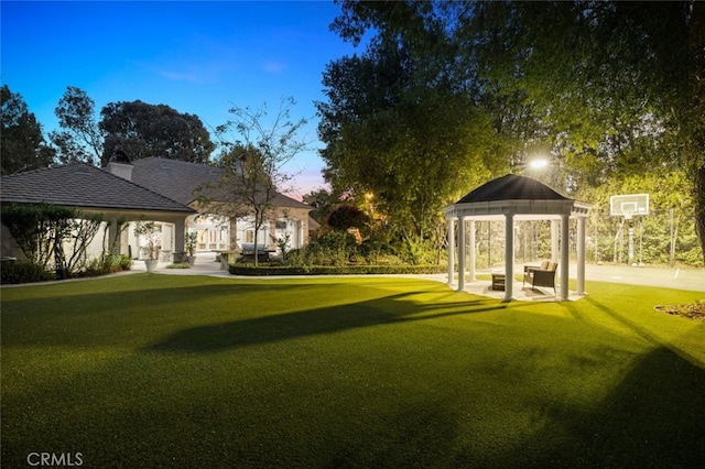 yard at dusk with a gazebo