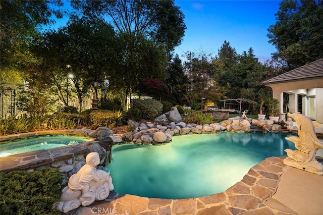 view of swimming pool with an in ground hot tub