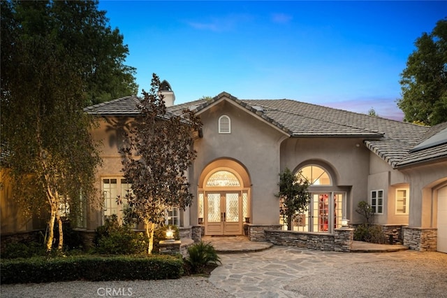 exterior space with french doors and a garage