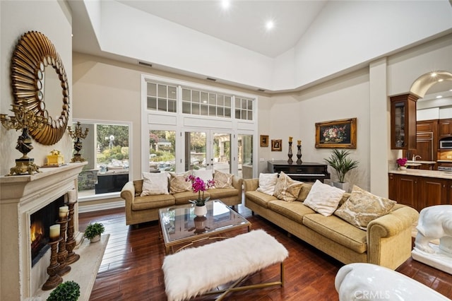 living room featuring french doors, dark hardwood / wood-style flooring, and high vaulted ceiling