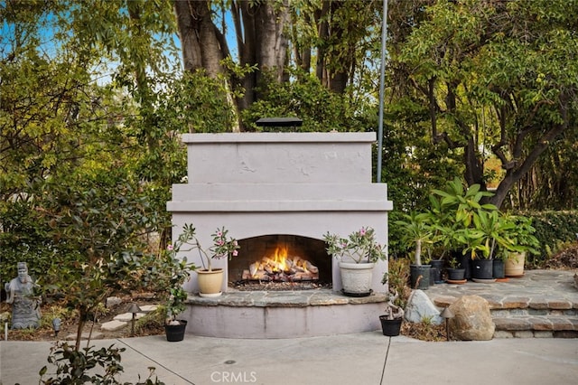 view of patio with an outdoor fireplace