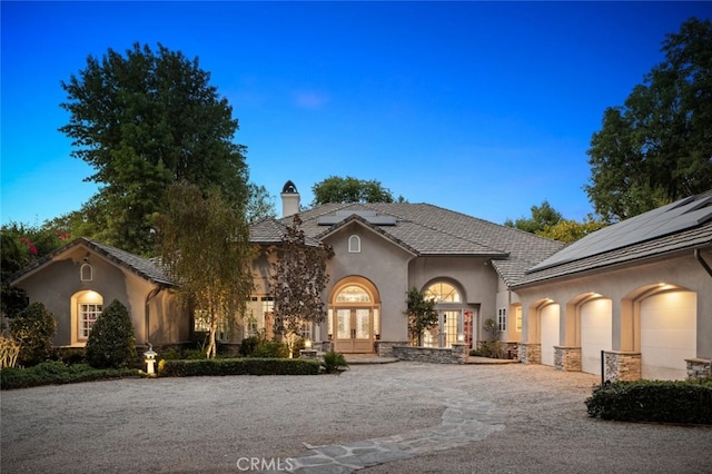 view of front of house with french doors and a garage