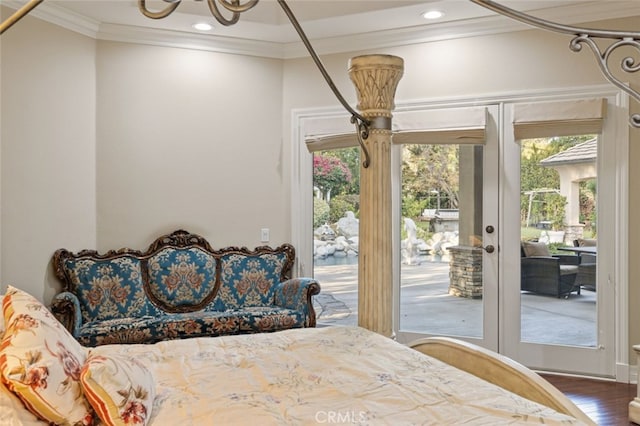 bedroom with wood-type flooring, ornamental molding, and access to outside