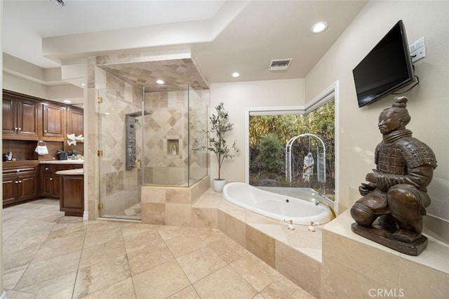 bathroom with vanity and separate shower and tub