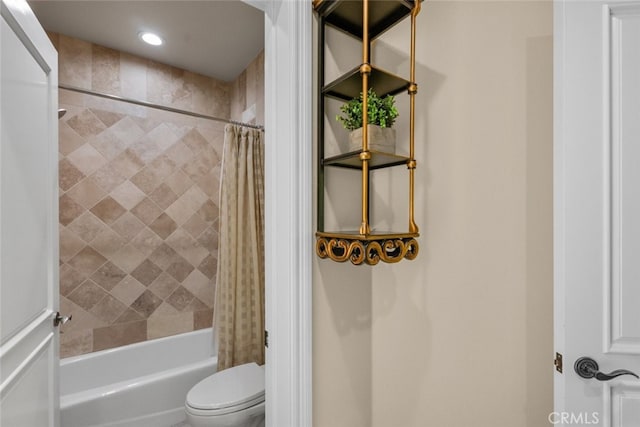 bathroom with shower / tub combo and toilet