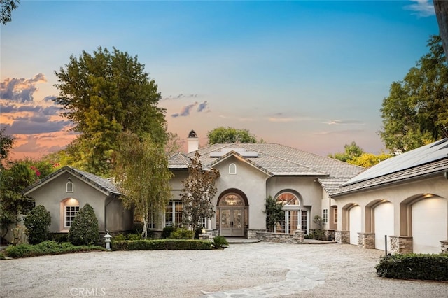 view of front of property featuring french doors and a garage