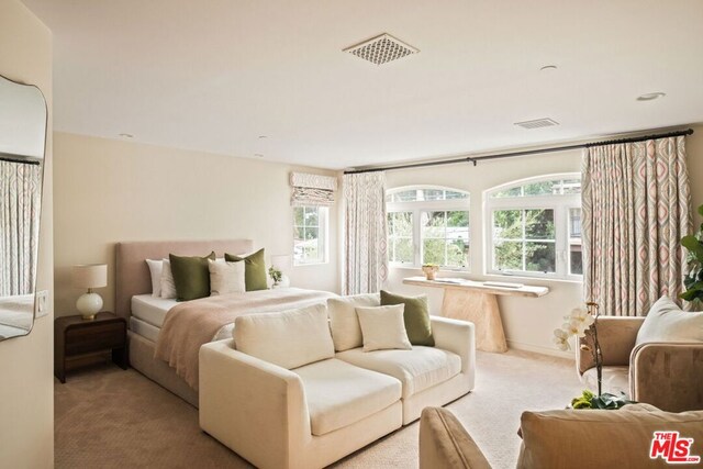 bedroom featuring light colored carpet