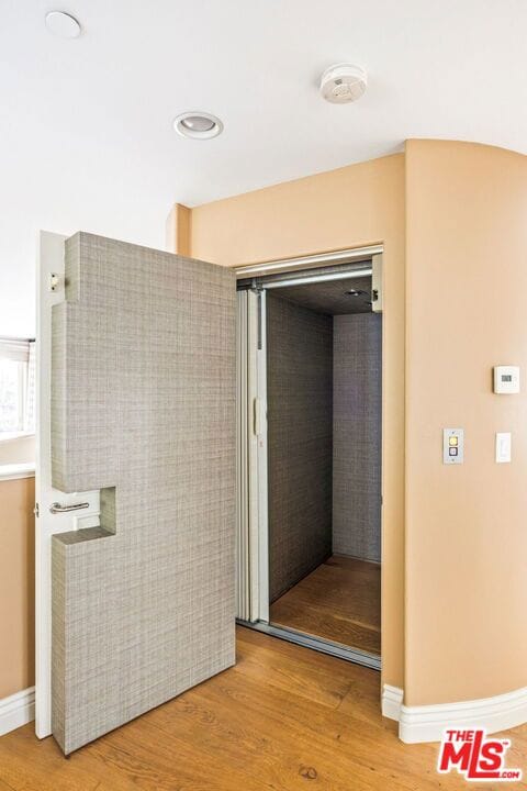 bathroom with hardwood / wood-style flooring