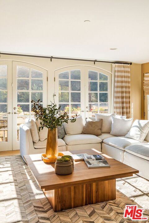 living room with french doors and light parquet flooring