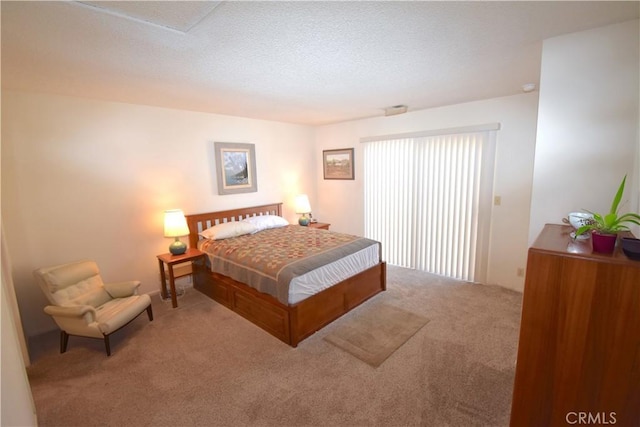 carpeted bedroom with a textured ceiling