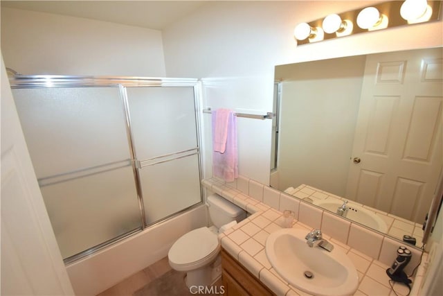 full bathroom with vanity, toilet, and bath / shower combo with glass door