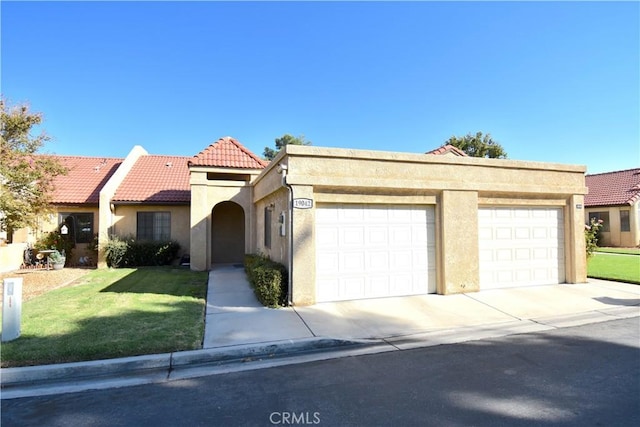 view of front of property featuring a garage and a front lawn