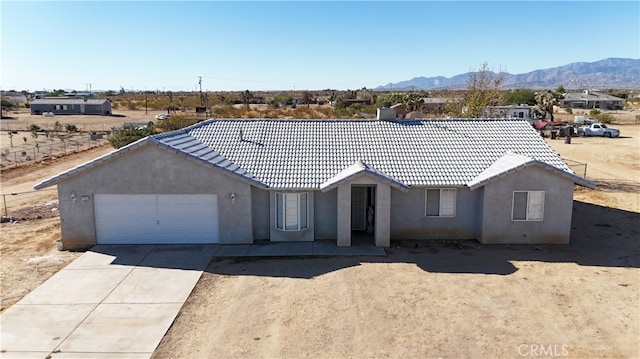 ranch-style home featuring a mountain view and a garage