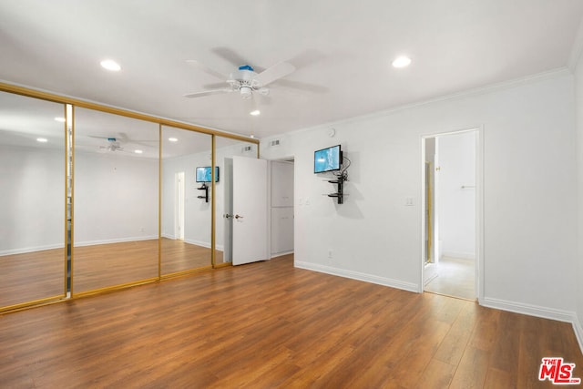 unfurnished room with hardwood / wood-style floors, ceiling fan, and crown molding