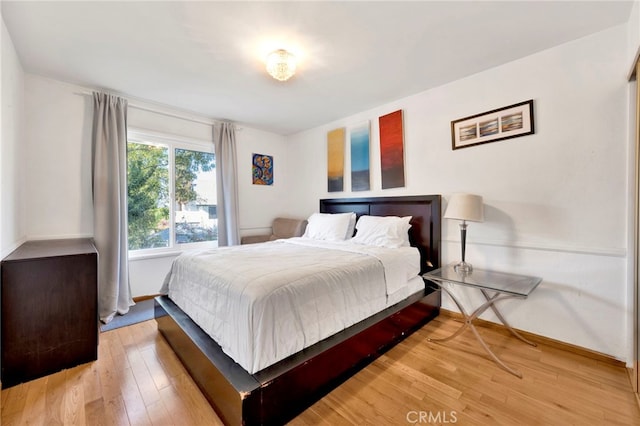 bedroom with wood-type flooring