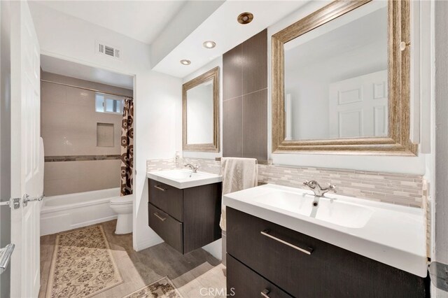 full bathroom with vanity, toilet, and shower / bath combo with shower curtain