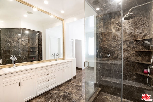 bathroom with vanity, crown molding, and a shower with shower door