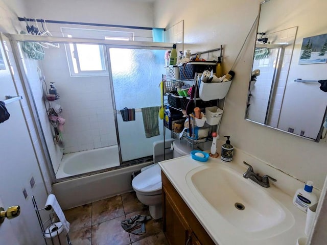 full bathroom with toilet, vanity, and shower / bath combination with glass door