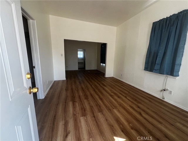 unfurnished room with dark wood-type flooring