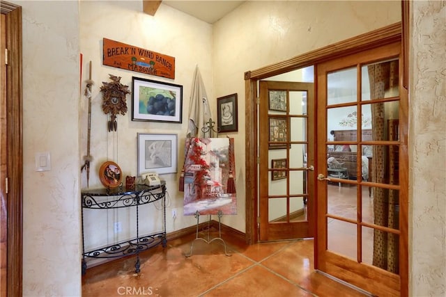 doorway to outside with a textured wall and french doors