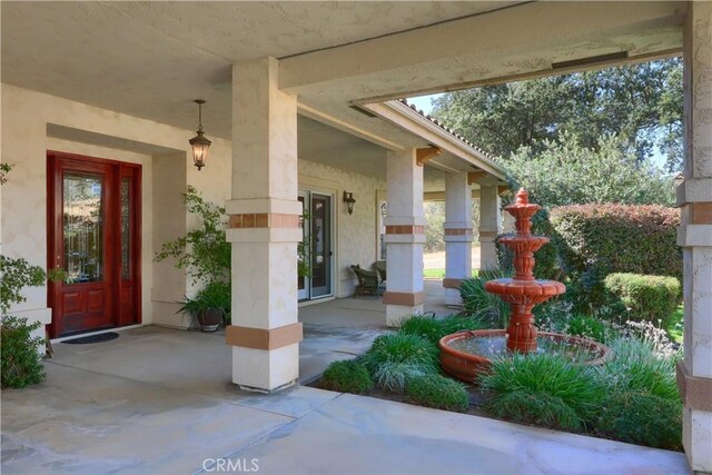entrance to property featuring stucco siding