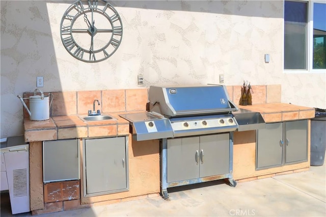 view of patio / terrace with grilling area, area for grilling, and a sink