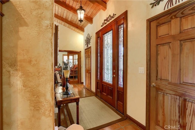 entrance foyer featuring vaulted ceiling with beams, wood ceiling, and baseboards