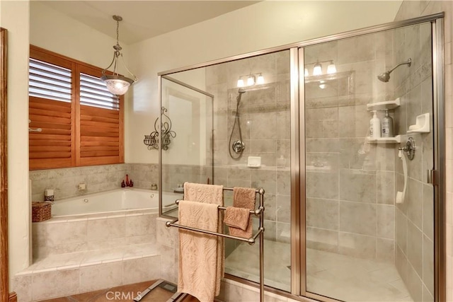 bathroom with a garden tub and a shower stall