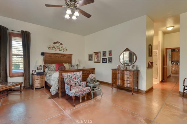 bedroom with a ceiling fan, finished concrete flooring, and baseboards